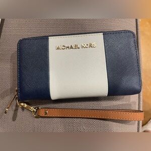 Michael Kors clutch wallet. Colors blue with white te and gold lettering